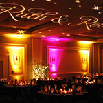 Pink and amber up lighting for Ruth and Rob's wedding reception decor.