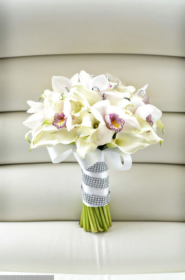 White calla lilies and orchids wedding bouquet with satin ribbon and crystal band. South Florida weddings by www.84WestStudios.com (954)236-9000.
