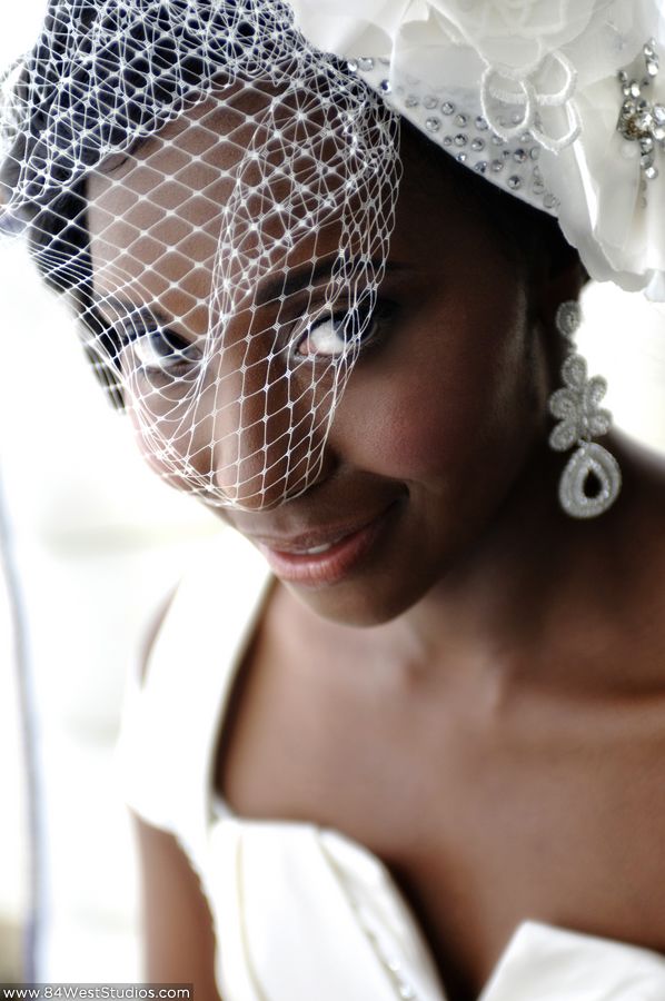 Beautiful bride with white birdcage veil and hair flower with crystal brooch decoration. South Florida weddings by www.84WestStudios.com (954)236-9000.